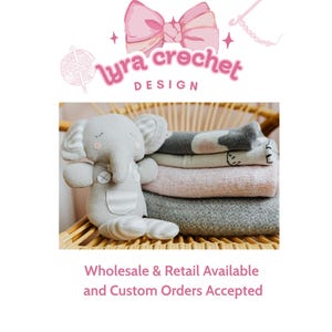 May include: A grey crocheted elephant toy with striped ears and a button detail sits beside a stack of folded blankets in shades of grey and pink. The image includes the text "Lyra Crochet Design".