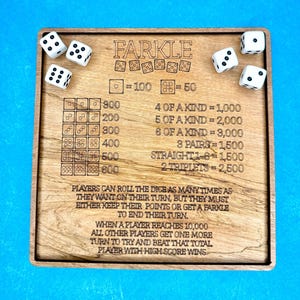 May include: Wooden Farkle game board with dice and rules etched into the surface. The board features the game's name, scoring details, and instructions. Six white dice with black dots are scattered around the board.