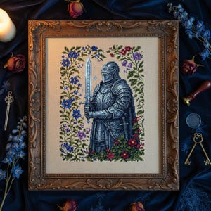 May include: Framed cross-stitch artwork of a knight in silver armor holding a sword, surrounded by a floral border of blue, purple, and red flowers. The artwork is in a decorative, ornate, brown wooden frame.