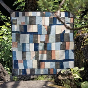 May include: A set of three ceramic mugs with a speckled, matte finish. The mugs are in shades of cream, light gray, and dark gray. Each mug has a simple, minimalist design, perfect for coffee or tea.