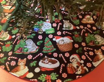 May include: A black Christmas tree skirt with a repeating pattern of cats wearing Santa hats, candy canes, and peppermint swirls.