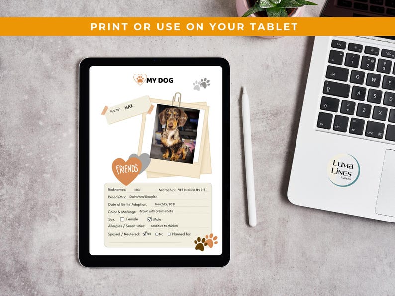 May include: A digital pet profile displayed on a tablet. The profile includes a photo of a Dachshund, the name "MAX", and details like breed, date of birth, and color. The tablet is next to a laptop and a stylus.