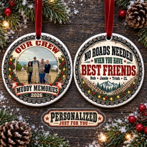 Op de afbeelding: Twee ronde keramische ornamenten met rode linten. Het linker ornament bevat een foto van vier personen, de tekst OUR CREW, MUDDY MEMORIES en 2026. Het rechter ornament toont de tekst NO ROADS NEEDED WHEN YOU HAVE BEST FRIENDS.