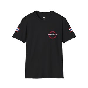 May include: Black t-shirt featuring the text "MUAY THAI FIGHT WEAR = AK9 =". The shirt has a Thai flag design on each sleeve and a small tag at the neckline.