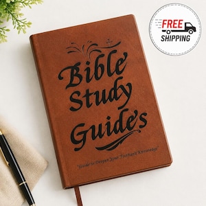 May include: A brown notebook with a smooth cover featuring the black text "Bible Study Guide's" and the smaller subtitle "Guide to Deepen Your Faith and Knowledge" printed on the front. A black pen is positioned near the bottom left corner.