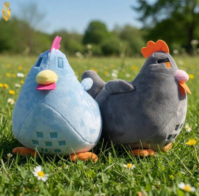 May include: Two plush chicken toys in a grassy field. One is light blue with a pink comb and yellow beak, the other is gray with an orange comb and pink beak. Both have orange feet.