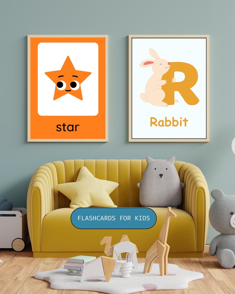 May include: Two framed educational wall art prints for children. The left print features an orange star with a face and the text star. The right print shows a light pink rabbit hugging a large orange letter R with the text Rabbit below it.