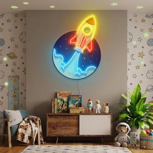 May include: A circular neon wall sign featuring a yellow and orange rocket ship launching into space. The rocket is surrounded by a dark blue circular background with white stars and a bright blue neon exhaust trail emanating from the base.