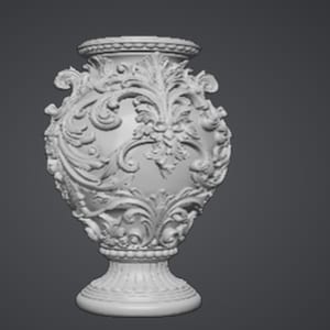 May include: A white, ornate vase with a detailed floral and scroll design. The vase has a wide, rounded body, a pedestal base, and a decorative rim. The intricate carvings and symmetrical composition give it a classic, elegant appearance.