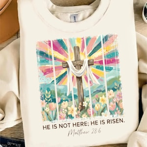 Er ist nicht hier, er ist auferstanden PNG, Matthäus 28: 6 Osterdesign, Wildblumen Kreuz Sublimation, Retro Christian Glaube Frühling Shirt Download