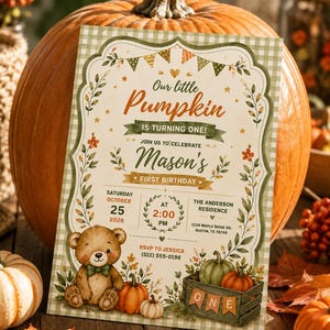 May include: A rectangular birthday invitation card featuring a green gingham border, a teddy bear, pumpkins, and autumn leaves. The text reads: Our little Pumpkin IS TURNING ONE! JOIN US TO CELEBRATE Mason's FIRST BIRTHDAY SATURDAY OCTOBER 25 2026 AT 2:00 PM THE ANDERSON RESIDENCE 1234 MAPLE RIDGE DR. AUSTIN, TX 78745 RSVP TO JESSICA (512) 555-0198.
