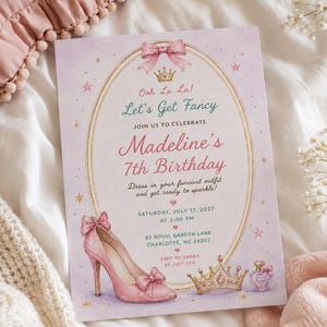 May include: A rectangular birthday invitation card with a light purple background featuring a gold oval frame, a pink bow, a crown, a high-heeled shoe, and a perfume bottle. The text reads: Ooh La La! Let's Get Fancy, Madeline's 7th Birthday, July 17, 2027.