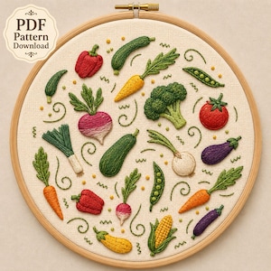 May include: An embroidery hoop containing a beige fabric panel with stitched vegetable motifs including red peppers, carrots, broccoli, radishes, leeks, peas, eggplants, and corn. A label in the top left corner reads PDF Pattern Download.