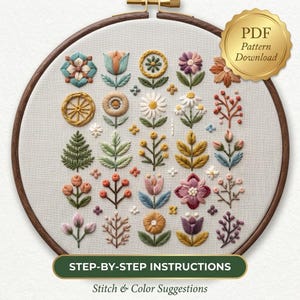 May include: An embroidery hoop containing a white fabric sampler with various stitched floral and botanical motifs in muted tones of pink, yellow, blue, green, and brown. A gold seal in the top right corner reads PDF Pattern Download.