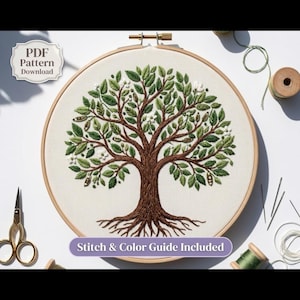 May include: A circular wooden embroidery hoop containing a fabric panel with a detailed tree design stitched in brown, green, and white thread. The text "PDF Pattern Download" and "Stitch & Color Guide Included" are visible on the image.