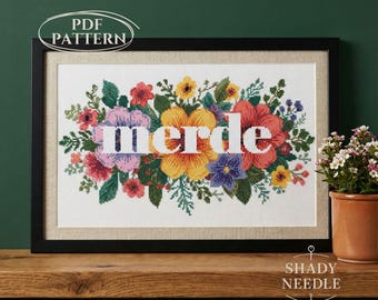 Subversive cross stitch PDF pattern with MERDE on floral background. Snarky xstitch desing for instant download.