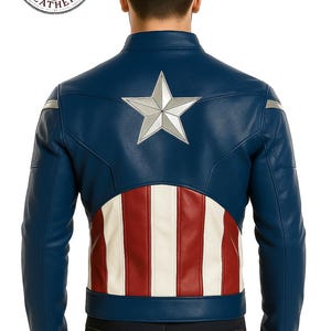 May include: A navy blue leather jacket with a silver star on the back. The jacket features red and white stripes at the lower back, and silver accents on the sleeves. The Essential Leathers logo is visible.