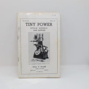 May include: A 1956 Tiny Power Steam Models and Supplies catalog featuring a black and white illustration of a No. 4 Reversing Marine Engine. The cover includes the text Chas. V. Arnold Model Engineer, Corvallis, Oregon, and P.O. Box 218.