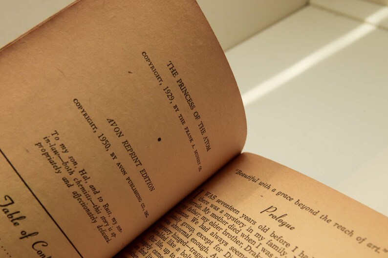 May include: Close-up of the copyright page of a vintage paperback book titled "The Princess of the Atom". The book was published in 1929 by The Frank A. Munsey Co. and reprinted in 1950 by Avon Publishing Co.