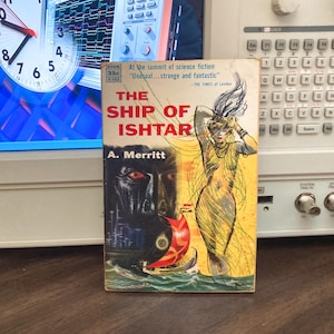 May include: Vintage paperback book titled "The Ship of Ishtar" by A. Merritt. The cover features a woman in a yellow dress, a dark face, and a red boat. The book is an Avon edition, priced at 35 cents.