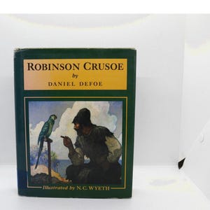 May include: A hardcover book titled Robinson Crusoe by Daniel Defoe, illustrated by N. C. Wyeth. The dark green cover features a yellow rectangular panel with black text and a central illustration of a person gesturing toward a green parrot.