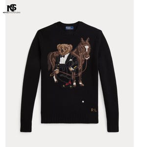 May include: A white ceramic mug with a black handle and the text "But First, Coffee" in a black, handwritten-style font. The mug is on a white surface.