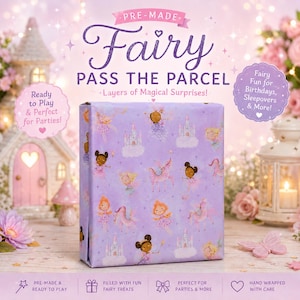 May include: A rectangular gift box wrapped in light purple paper featuring a repeating pattern of fairies, castles, and unicorns. The text on the box reads PRE-MADE Fairy PASS THE PARCEL Layers of Magical Surprises! Ready to Play & Perfect for Parties!