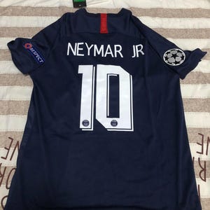 May include: A set of three ceramic mugs with a speckled, matte finish. The mugs are in shades of cream, light gray, and dark gray. Each mug has a simple, minimalist design and a rounded handle.