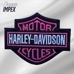 May include: Black and pink Harley-Davidson Cycles patch. The patch features the Harley-Davidson logo with white lettering and pink accents. The patch is embroidered and has a black border. The text "Dayan Impex" is in the upper left corner.
