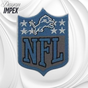 May include: Embroidered patch featuring the Detroit Lions logo. The patch is shield-shaped with a blue background, a white lion, white stars, and the letters "NFL" in blue and gray. The text "Dayan IMPEX" is in the upper left corner.