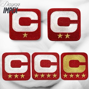 May include: A collection of embroidered patches. Each patch is a red square with a white or gold letter "C" and gold stars. The patches vary in the number of stars, from one to five.