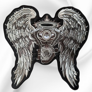 May include: A large embroidered patch featuring a central motorcycle engine block topped with a halo, flanked by two expansive, detailed feathered wings. The design uses shades of silver, grey, and brown thread on a solid black fabric background.