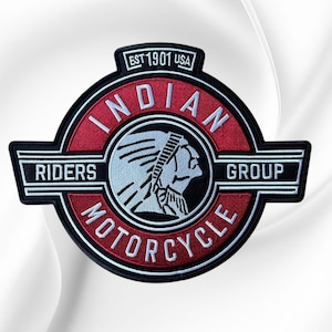 May include: A circular embroidered patch featuring a red and black design with a white profile of a Native American figure. The text reads INDIAN MOTORCYCLE RIDERS GROUP and EST 1901 USA in white lettering. The patch has a black border and white accents.