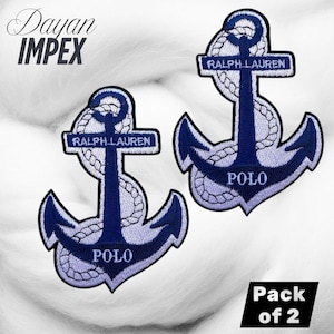 May include: Two navy blue and white embroidered anchor patches with the text "RALPH LAUREN POLO". The patches are in the shape of an anchor with rope detailing. The patches are sold as a pack of two.