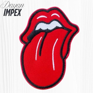 May include: Embroidered patch featuring the iconic red lips and tongue logo with black outline and white teeth. The patch has the text "Dayan IMPEX" in the upper left corner. This patch is a classic rock and roll symbol.