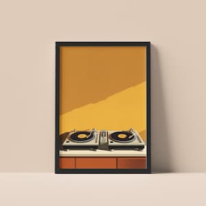 A framed art print of two DJ turntables against a mustard yellow wall hangs on a neutral surface.