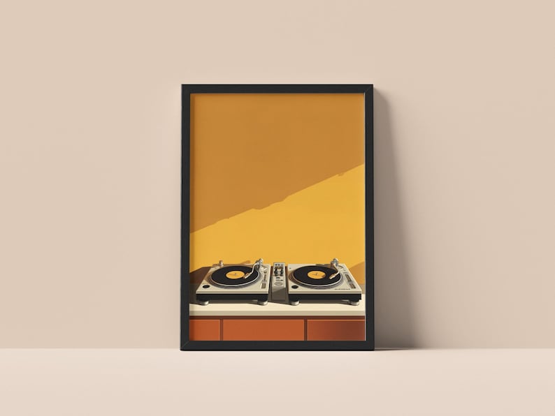 A framed art print of two DJ turntables against a mustard yellow wall hangs on a neutral surface.