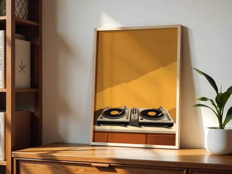 A framed art print showing turntables is displayed on a wooden cabinet next to a bookshelf and a potted plant.