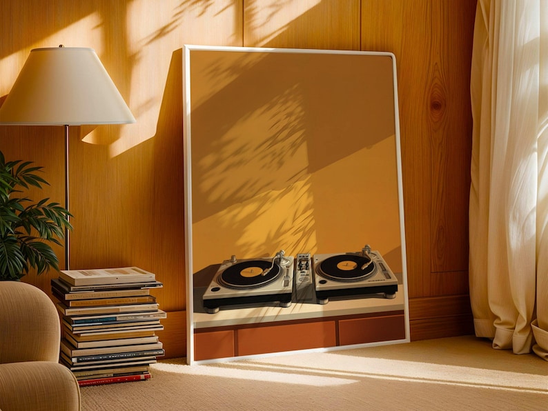 A white-framed poster of DJ turntables stands on the floor against a wood-paneled wall next to a stack of books and a lamp.