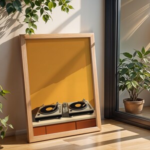 A framed turntable poster leans on wooden flooring near a glass sliding door and green houseplants.