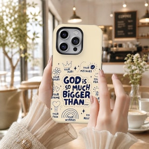 May include: A cream-colored phone case with a black camera module. The case features the text "GOD is SO MUCH BIGGER THAN..." surrounded by small illustrations and words like "Doubt", "Hurt", and "Mistakes".