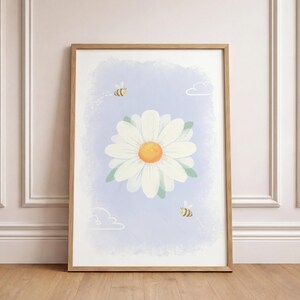 May include: A framed art print featuring a large white daisy with a yellow center against a light blue background. Two cartoon bees and two white clouds are also depicted. The artwork is in a wooden frame.