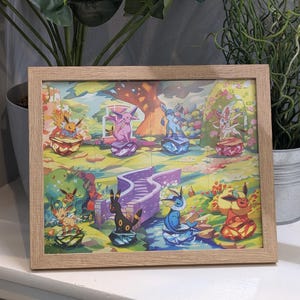 May include: A framed print depicting colourful cartoon characters in a lively outdoor scene. The artwork shows several figures on plinths, with a purple staircase and a tree in the background. The frame is made of light-coloured wood.