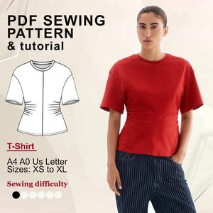May include: A red t-shirt with short sleeves and a fitted waist, paired with blue and white striped pants. The image also includes a line drawing of the t-shirt and text that reads "PDF Sewing Pattern & tutorial" and "T-Shirt".