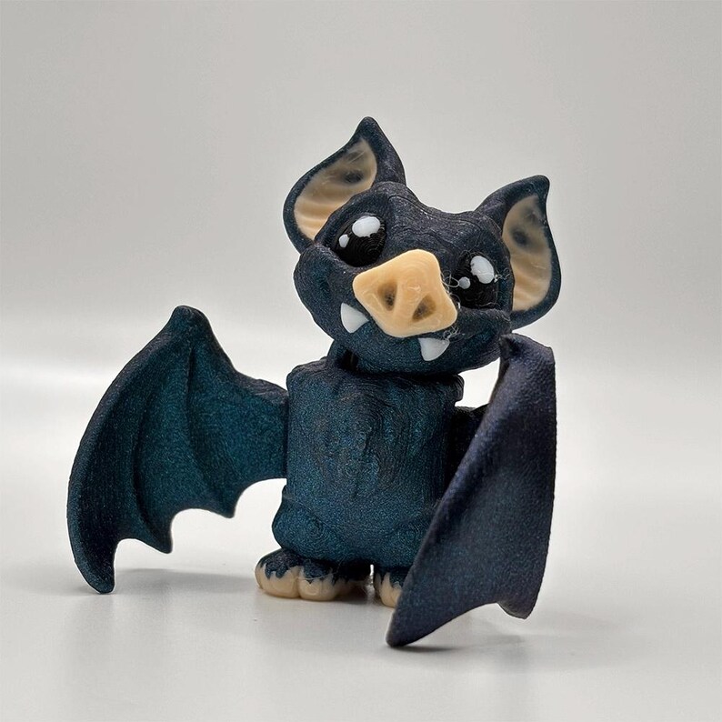 A 3D-printed vampire bat fidget with movable head and wings, available from 3D Busy Hands.