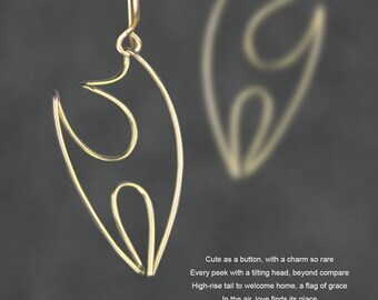 May include: A pair of gold-toned earrings with a unique abstract design. The earrings are made of thin wire that is bent into a flowing, organic shape.