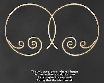 May include: A pair of gold hoop earrings with a spiral design. The earrings are large and have a delicate, intricate design.