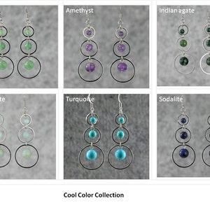 May include: A collection of earrings featuring different gemstones in cool colors. The earrings are made with silver hoops and feature three gemstone beads in each earring. The gemstones include jade, amethyst, Indian agate, amazonite, turquoise, and sodalite. The earrings are labeled with the name of the gemstone. The text "Cool Color Collection" is at the bottom of the image.