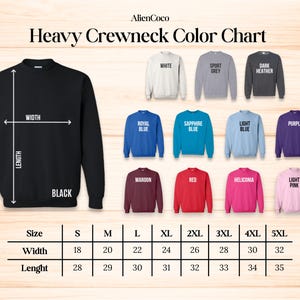 May include: A color chart for heavy crewneck sweatshirts. The chart displays various colors, including black, white, sport grey, dark heather, royal blue, sapphire blue, light blue, purple, maroon, red, heliconia, and light pink. Measurements are provided in inches for width and length.