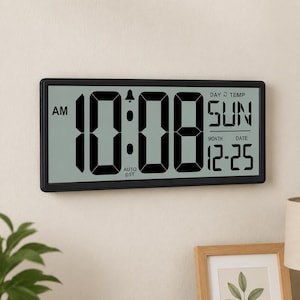 May include: A rectangular digital clock with a black frame displays the time as 10:08 AM. The day is Sunday, and the date is 12-25. The clock also shows the temperature and has an auto DST setting.